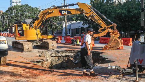 Crews continue working Wednesday to repair a large sinkhole along Ponce de Leon Avenue in Midtown Atlanta on Tuesday, June 27, 2023.