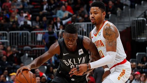 Caris LeVert of the Brooklyn Nets drives against Kent Bazemore of the Atlanta Hawks at Philips Arena on January 12, 2018 in Atlanta, Georgia.    (Photo by Kevin C. Cox/Getty Images)