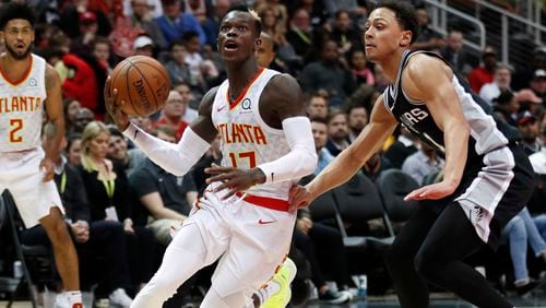 Atlanta Hawks guard Dennis Schroder (17) drives past San Antonio Spurs forward Kyle Anderson (1) as he goes to the basket in the second half of an NBA basketball game Monday, Jan. 15, 2018, in Atlanta. The Hawks won 102-99. (AP Photo/John Bazemore)