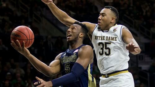 Georgia Tech's Josh Okogie (5) goes up to shoot as Notre Dame's Bonzie Colson (35) defends during the first half of an NCAA college basketball game Saturday, Dec. 30, 2017, in South Bend, Ind. (AP Photo/Robert Franklin)