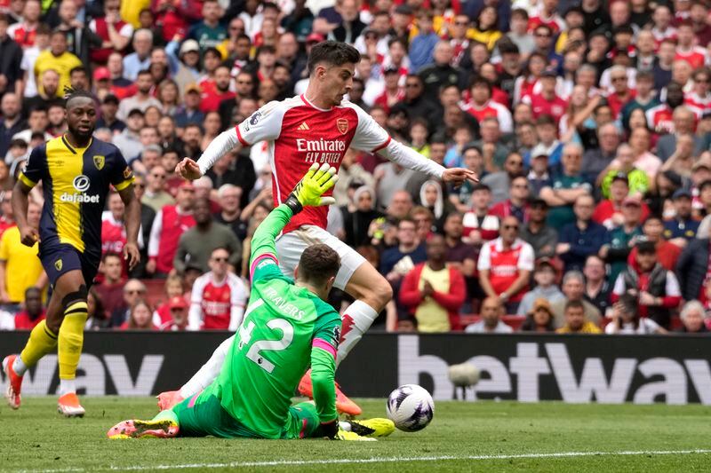 Bournemouth's goalkeeper Mark Travers challenges for the ball with Arsenal's Kai Havertz during the English Premier League soccer match between Arsenal and Bournemouth at Emirates Stadium in London, England, Saturday, May 4, 2024. (AP Photo/Frank Augstein)