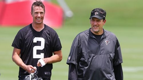 Matt Ryan and quarterbacks coach Greg Knapp share a laugh while working together during team practice on Tuesday, June 5, 2018, in Flowery Branch.