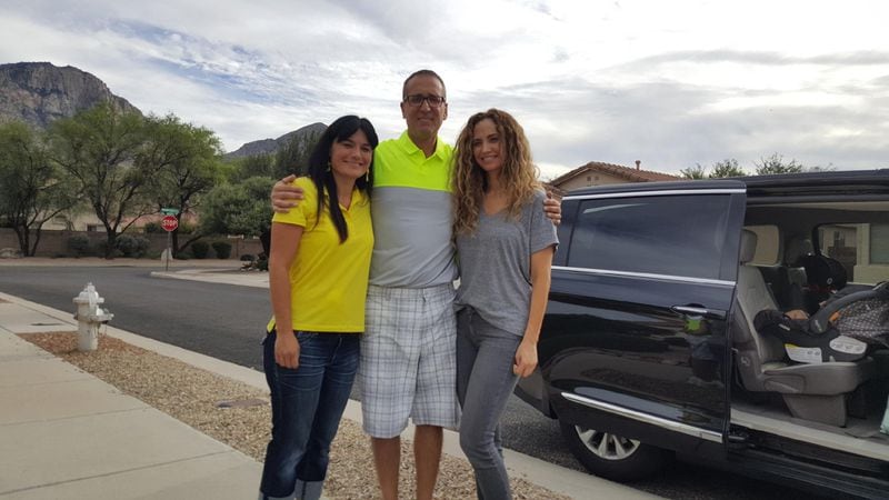 Ron Bell, center, poses with his girlfriend, Jennifer Pendley, at left, and Kerri Pastner, the wife of Georgia Tech basketball coach Josh Pastner, outside the home Bell shares with Pendley in Tucson, Arizona. Kerri Pastner visited Bell and Pendley with her three daughters. 