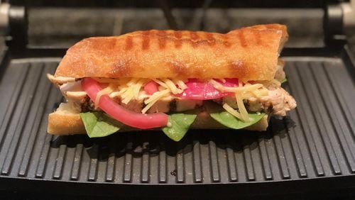 Slices of leftover grilled chicken breast, spinach, Gruyere, and pickled red onions get pressed into dinner duty. CONTRIBUTED BY KELLIE HYNES