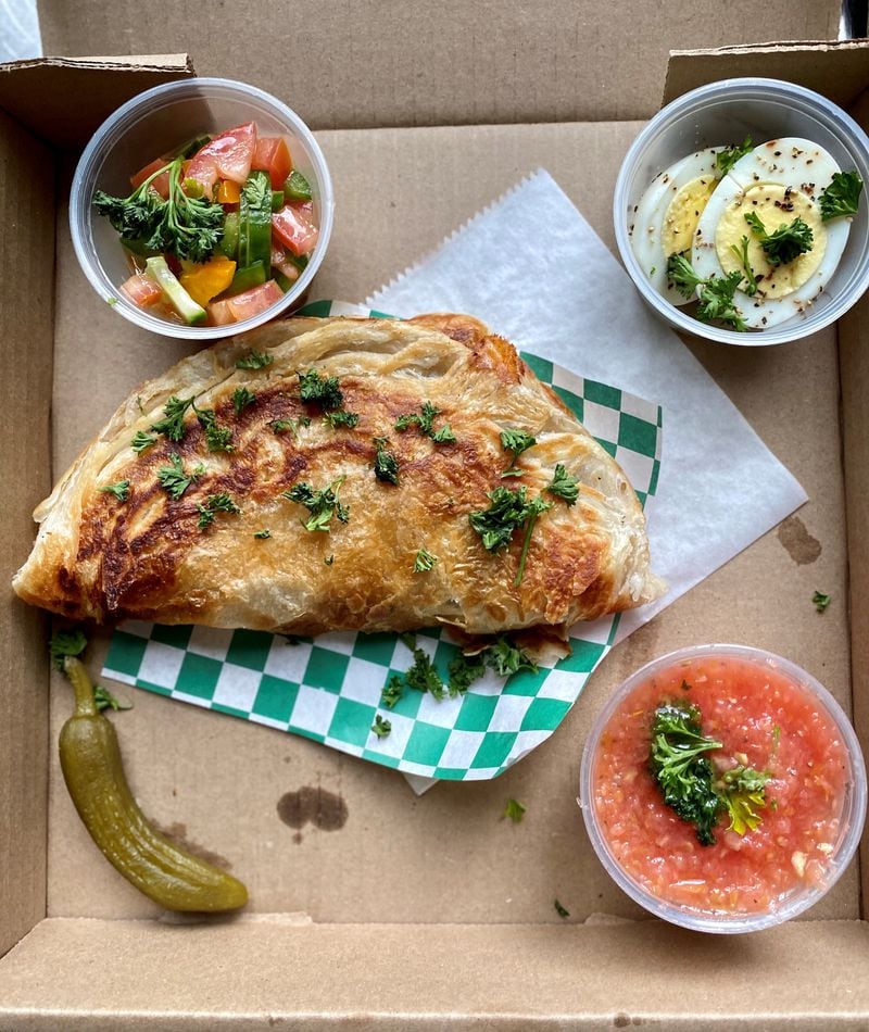 Alpharetta’s Vertigo Cafe makes a version of the Yemenite flatbread malawach — they call it ziva and it’s served with the traditional accompaniments of Israeli salad, boiled egg and crushed tomatoes. Wendell Brock for The Atlanta Journal-Constitution