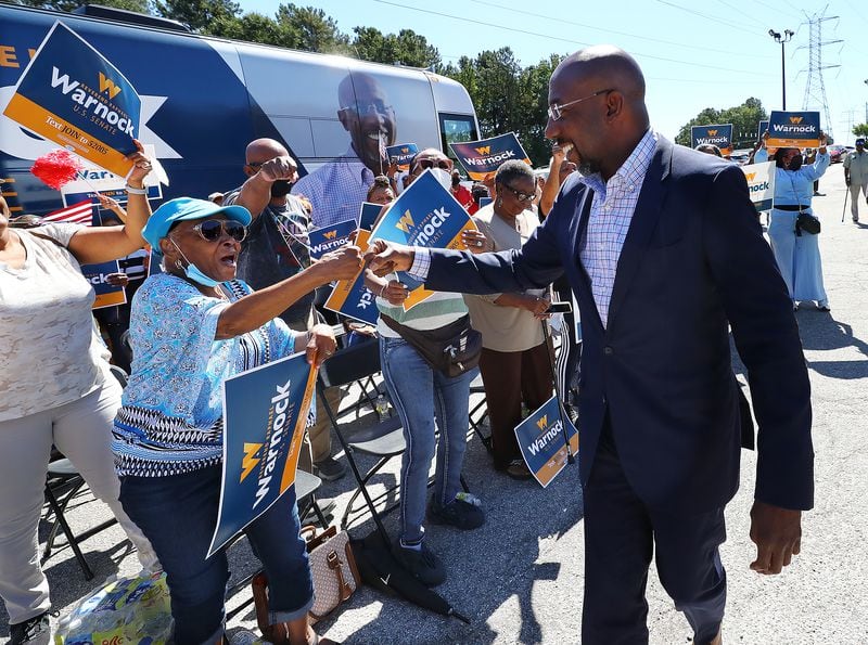 092622 Atlanta: Senator Reverend Raphael Warnock gives supporters fist bumps while arriving for a campaign stop at Cascade Family Skating on Monday, Sept. 26, 2022, in Atlanta.   “Curtis Compton / Curtis Compton@ajc.com