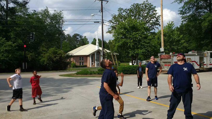 A group of boys was challenged to a game of basketball by Alpharetta firefighters.