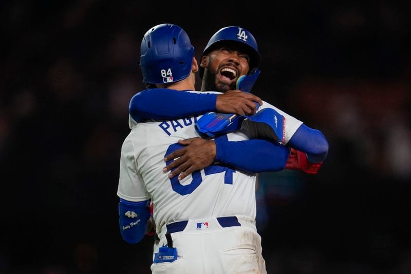 Los Angeles Dodgers' Andy Pages (84) celebrates with Teoscar Hernández after a single during the eleventh inning of a baseball game against the Atlanta Braves in Los Angeles, Friday, May 3, 2024. Will Smith scored. The Dodgers won 4-3. (AP Photo/Ashley Landis)
