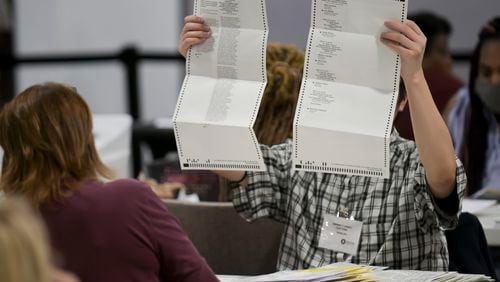 Workers sort absentee ballots Tuesday, Nov. 8, 2022 at the Gwinnett Voter Registrations and Elections building. (Daniel Varnado/For the AJC)
