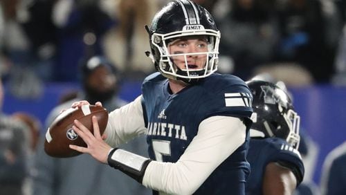 Marietta quarterback Harrison Bailey (5) attempts a pass in the first half against Lowndes during the Class AAAAAAA high school football state title game at Georgia State Stadium Saturday, December 14, 2019 in Atlanta. (JASON GETZ/SPECIAL TO THE AJC)