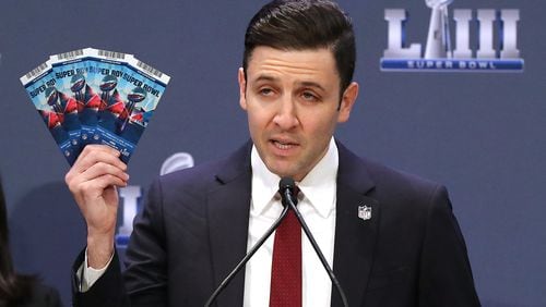 Michael Buchwald, NFL Senior Counsel, Legal, holds up real Super Bowl tickets during the National Football League and law enforcement agencies press conference announcing the latest results of seizures of counterfeit game-related merchandise and tickets during a press conference at the Georgia World Congress Center on Thursday, Jan. 31, 2019, in Atlanta.   Curtis Compton/ccompton@ajc.com