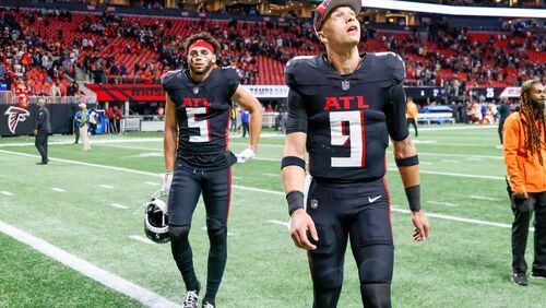 Atlanta Falcons quarterback Desmond Ridder (9) looks up as he leaves the field, followed by Atlanta Falcons wide receiver Drake London (5) after the Falcons lose against the Tampa Bay Buccaneers 29-25 at Mercedes-Benz Stadium on Sunday, Dec. 10, 2023.Miguel Martinez/miguel.martinezjimenez@ajc.com