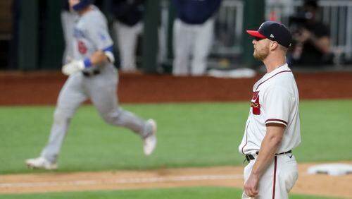 Not a sight the Braves want to see in 2021: One Will Smith - the Braves reliever - is dejected while the other Will Smith - of the Los Angeles Dodgers - trots by after his home run in last season's NLCS. (Curtis Compton / Curtis.Compton@ajc.com)