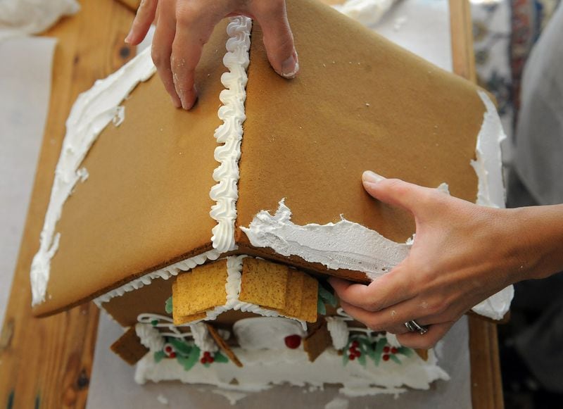 Build the sides of your house first, and make sure to use lots of icing to “glue” the rooftop on. We used extra icing to create a “snow bank” on the edges. Sprinkled with confectioners’ sugar, the effect gives the house the look of newly fallen snow. 