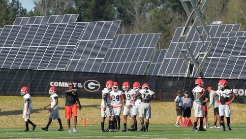 The University of Georgia football team practiced last spring next to a solar farm. Such farms have sprouted across the state as Georgia Power boosted its use of solar power. BRANT SANDERLIN/BSANDERLIN@AJC.COM