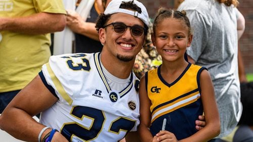 Georgia Tech safety Jalen Johnson (23) poses for a photo with his little sister during Fan Day at Bobby Dodd Stadium on Aug. 12, 2017. -- Danny Karnik/GT Athletics