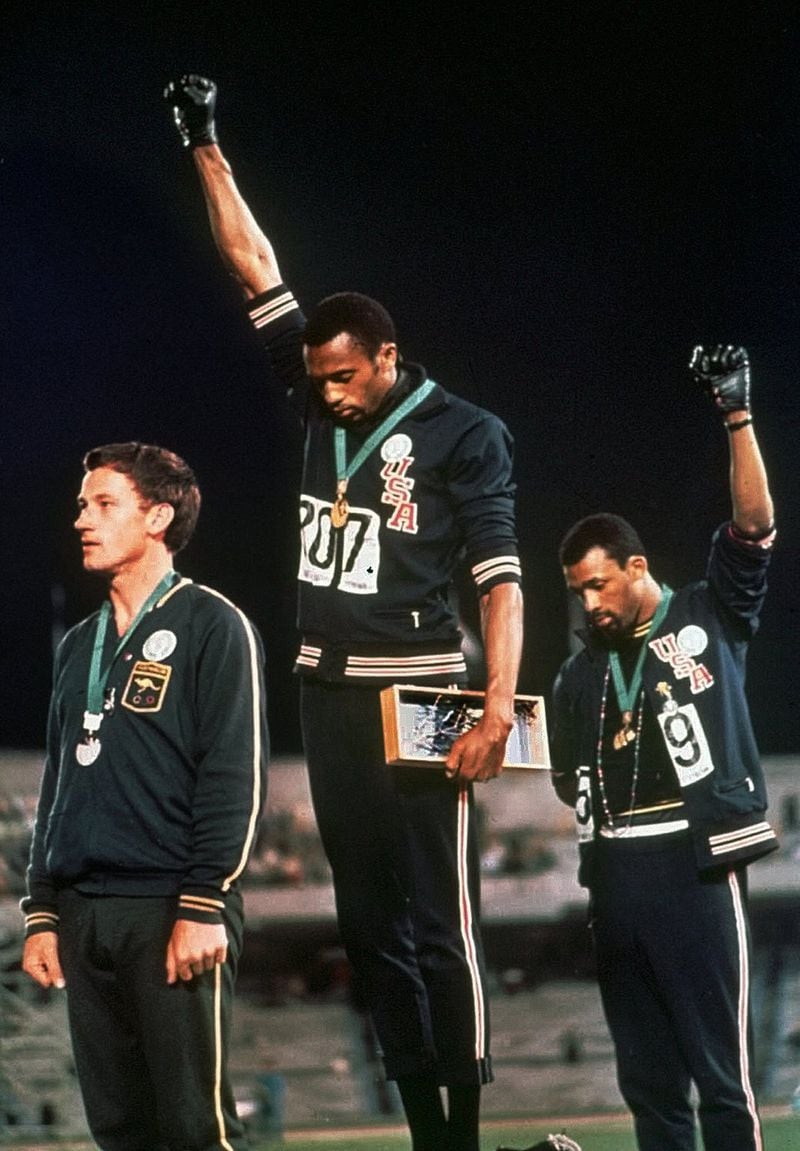 Extending gloved hands skyward in racial protest, U.S. athletes Tommie Smith, center, and John Carlos stare downward during the playing of “The Star-Spangled Banner” after Smith received the gold and Carlos the bronze medal in the 200-meter run at the Summer Olympic Games in Mexico City. Carlos and Smith staged one of the most iconic protests in sports history when they raised their fists during the medals ceremony at the 1968 Olympics. They were sent home immediately by the U.S. Olympic Committee, which spent decades wrestling with how and whether the sprinters should be honored. The International Olympic Committee has rules against using the games for political statements, though Scott Blackmun of the U.S. Olympic Committee said, “Our stance on this is fairly clear, and we recognize the rights of athletes to express themselves.” (AP Photo/File)