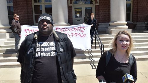 Samantha Binion (right) of Newnan and Haroun Wakil of Atlanta speak to the press outside the Coweta County courthouse during a press conference opposing the neo-Nazi rally planned for Saturday. Hyosub Shin / hshin@ajc.com