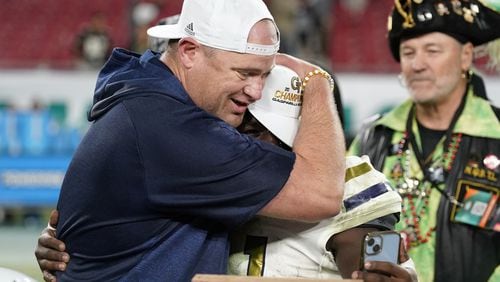 Georgia Tech coach Brent Key hugs Jamal Haynes after the Yellow Jackets' 30-17 victory over Central Florida on Friday.