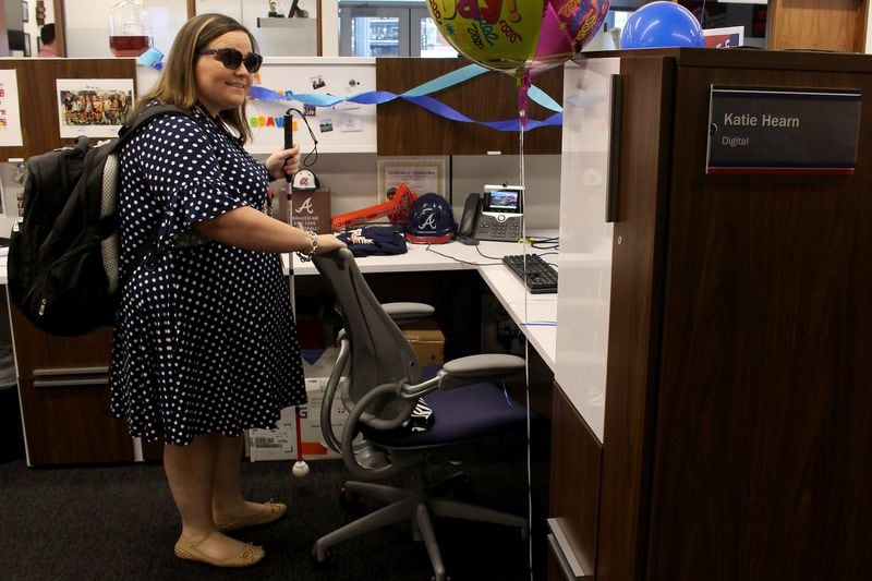 Katie Hearn arrives at her job with the Atlanta Braves’ social media department at SunTrust Park. Katie, a die-hard Braves fan, began to lose her vision over a year ago, but that didn’t stop her from going back to work as soon as she could. JENNA EASON / JENNA.EASON@COXINC.COM
