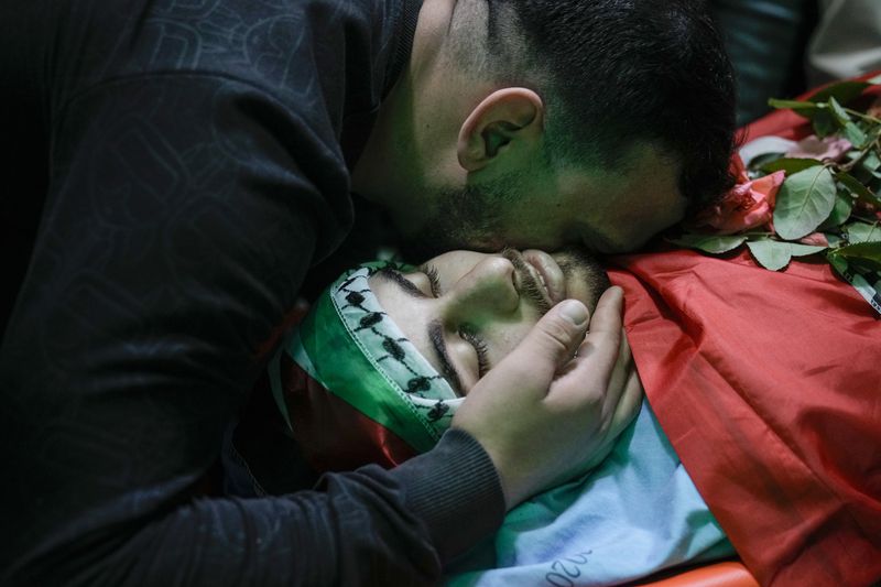 A Palestinian man kisses Yazan Shtayyeh,17, killed in an Israeli military raid, during his funeral in West Bank village of Salem, Near the Palestinian town of Nablus, Monday, April 15, 2024. (AP Photo/Majdi Mohammed)