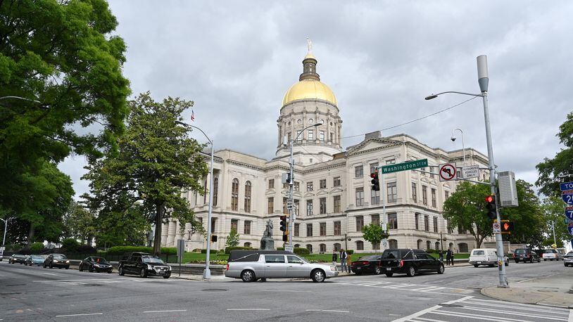 A processional led by hearses from the 9th District of Georgia Funeral Service Practitioners Association circles the state Capitol on Thursday, April 30, 2020, to illustrate what protesters fear will be the deadly consequences of Gov. Brian Kemp’s decision to allow his sheltering-in-place order to expire. (Hyosub Shin / Hyosub.Shin@ajc.com)
