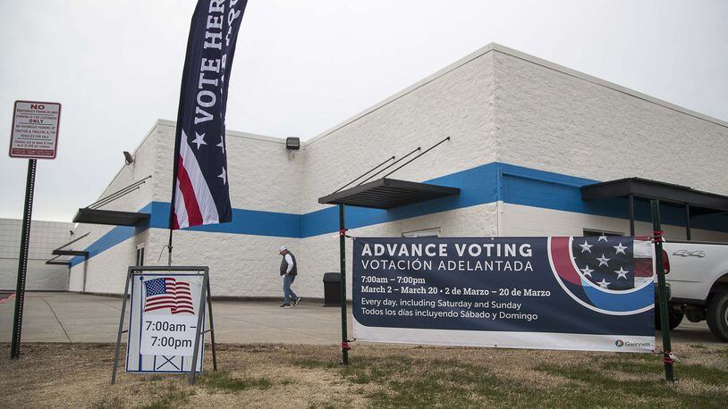 Signs for early voting are displayed in March outside the Gwinnett Voter Registrations and Elections office building in Lawrenceville. (ALYSSA POINTER/ALYSSA.POINTER@AJC.COM)