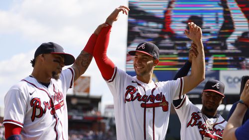 Braves first baseman Matt Olson (center) gets help from teammates Orlando Arcia (left) and Ozzie Albies (right) as the team is recognized before the last game of the season at Truist Park on Sunday, Oct. 1, 2023, in Atlanta. Miguel Martinez / miguel.martinezjimenez@ajc.com
