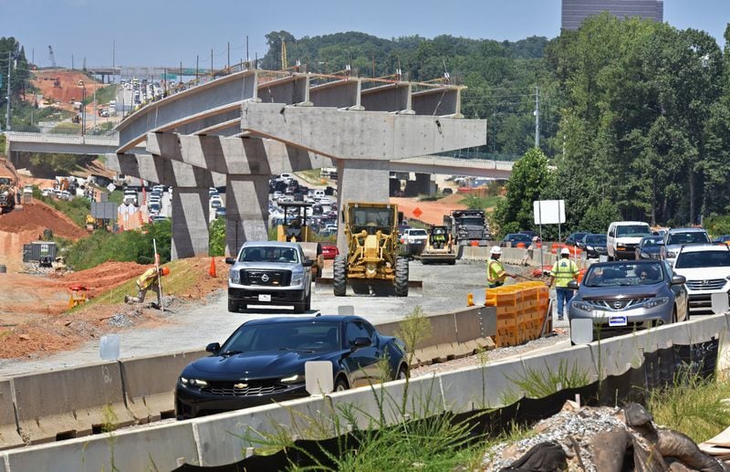 Workers at the construction site of the I-285 interchange at Ga. 400 in Sandy Springs on Friday, August 8, 2019. (Hyosub Shin / Hyosub.Shin@ajc.com)