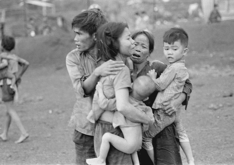 Civilians huddle together after an attack by South Vietnamese forces. Dong Xoai, June 1965. Credit: Courtesy of AP/Horst Faas