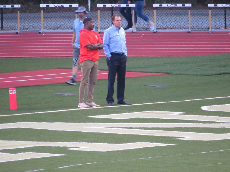 Auburn coach Gus Malzahn (right) and Tigers receivers coach Cody Burns attend Denmark's football game at Blessed Trinity in Roswell on Friday, Oct. 11, 2019. (Adam Krohn/special)