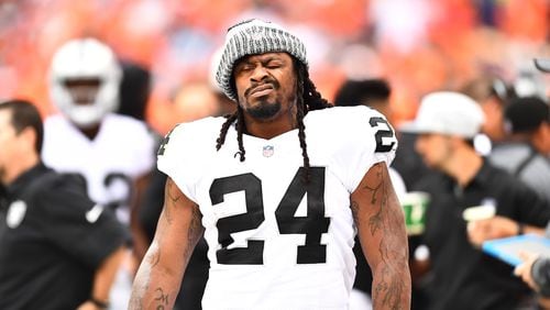 Oakland Raiders running back Marshawn Lynch (24) walks the sidelines during the third quarter against the Denver Broncos at Sports Authority Field at Mile High.