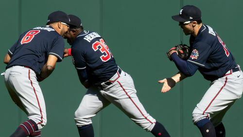Braves outfielders Eddie Rosario (8), Guillermo Heredia (38) and Adam Duvall celebrate their victory over the San Francisco Giants Sunday, Sept. 19, 2021, in San Francisco. (D. Ross Cameron/AP)