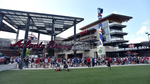 Fans wait in line to get into SunTrust Park before the Braves’ game against the Milwaukee Brewers on Aug. 10.