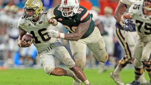 Miami defensive lineman R.J. McIntosh (80) chases Georgia Tech quarterback TaQuon Marshall (16) late in the fourth quarter at Hard Rock Stadium in Miami on Saturday, Oct. 14, 2017. The host Hurricanes won, 25-24. (Al Diaz/Miami Herald/TNS)
