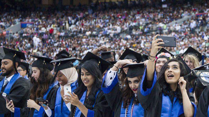 Georgia State University undergraduate students take part in the 2018 commencement ceremony at Georgia State Stadium in Atlanta on May 10, 2018. It has the largest enrollment of any university in Georgia, with about 53,000 students. A bill in the Georgia House of Representatives would allow all high school graduates, regardless of their immigration status, to pay in-state tuition at any public college or university in the state, with some conditions. AJC FILE PHOTO / REANN HUBER 2018