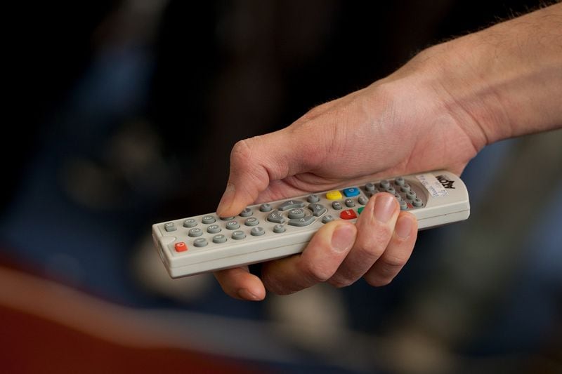 A man uses a remote control.