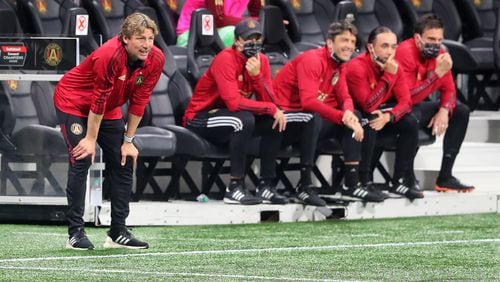 Atlanta United head coach Gabriel Heinze (far left) and his coaching staff look over the team as they face the Philadelphia Union in a Champions League quarterfinals match Tuesday, April 27, 2021, in Atlanta. (Curtis Compton / Curtis.Compton@ajc.com)