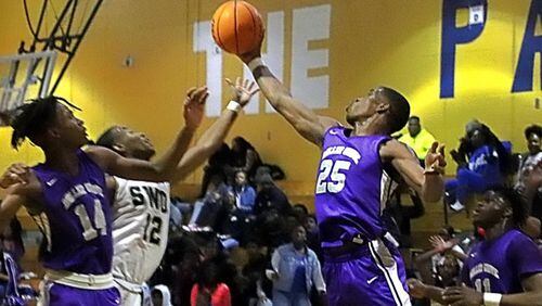 Miller Grove’s Jahmil Barber (14) and Jamarcus Glover (25) contest for a loose ball with Southwest DeKalb’s Chandler Sanders.
