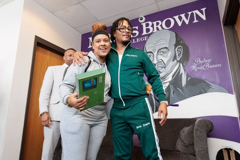 Rapper T.I. greets a student, who was given a new tablet at Morris Brown on Monday, August 15, 2022. (Arvin Temkar / arvin.temkar@ajc.com)