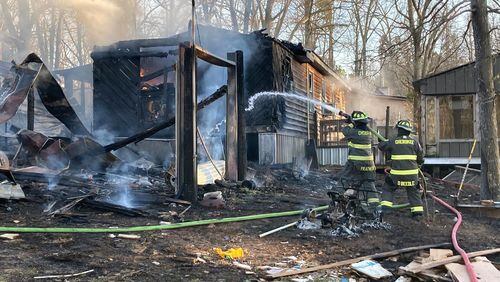 Investigators believe two boys playing with a lighter caused a fire that heavily damaged a Cherokee County home.