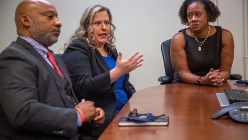 Investigator Crispin Henry (from left), prosecuting attorney Agatha Romanowski and DeKalb County District Attorney Sherry Boston talk about closing a 24-year-old sexual assault case.