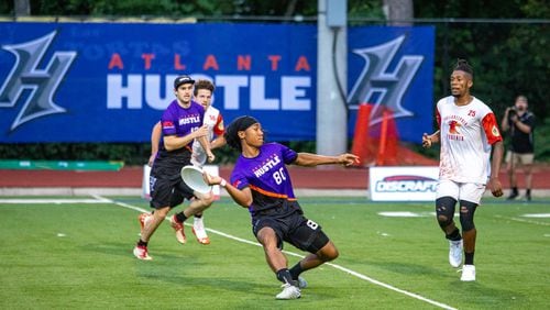 Antoine Davis, #80, a player for the Hustle, Atlanta's American Ultimate Disc League team, passes during a game against Philadelphia at St. Pius X High School Field on Saturday, June 26, 2021. The Hustle won 24-17. (Jenni Girtman for The Atlanta Journal-Constitution)