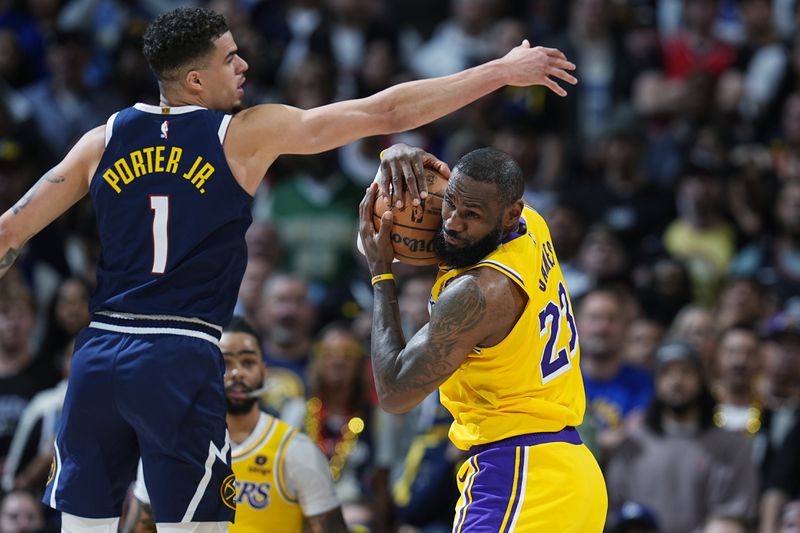 Los Angeles Lakers forward LeBron James, right, pulls in a rebound as Denver Nuggets forward Michael Porter Jr. (1) defends in the second half of Game 5 of an NBA basketball first-round playoff series Monday, April 29, 2024, in Denver. (AP Photo/David Zalubowski)