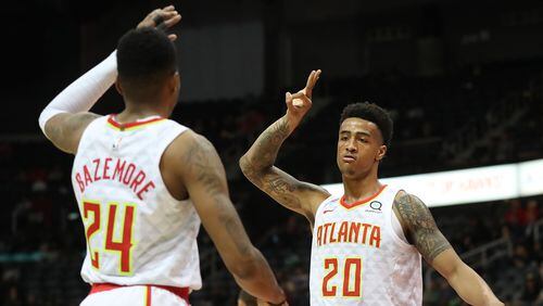 Hawks forward John Collins reacts when Kent Bazemore hits a three pointer against the Utah Jazz during a 104-90 victory in a NBA basketball game on Monday, January 22, 2018, in Atlanta.   Curtis Compton/ccompton@ajc.com