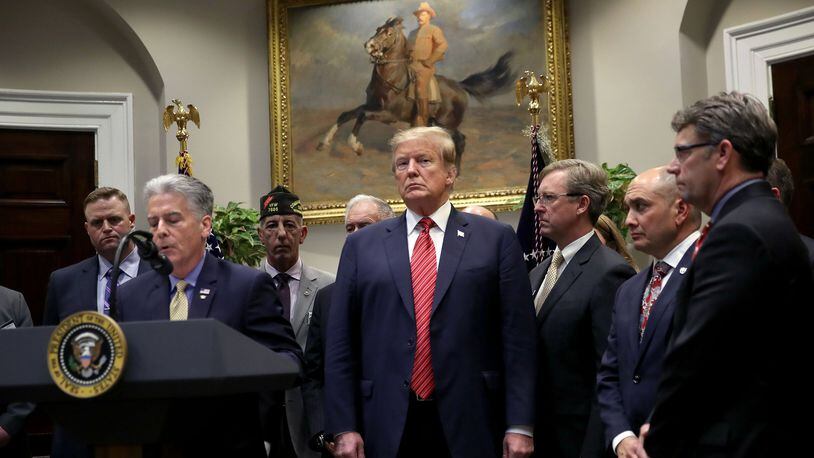 President Donald Trump listens as Frank Larkin, left, a retired Navy Seal, speaks during an executive order signing ceremony at the White House on the National Roadmap to Empower Veterans and End Veteran Suicide March 5, 2019 in Washington, D.C. Larkin’s son Ryan, also a Navy Seal, took his own life due to the effects of a traumatic brain injury sustained during his military career. Win McNamee/Getty Images