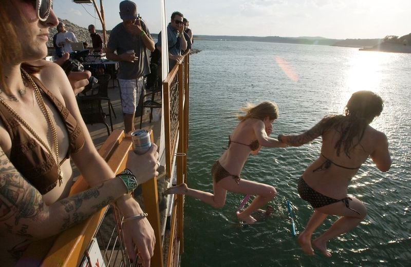 Party goers jump into Lake Travis from the deck of the Ark, a barge that hosts floating parties, in July 2011, a month when Austin recorded 29 days of 100-degree weather. Zach Ornitz/AMERICAN-STATESMAN