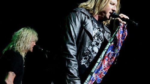 Def Leppard singer Joe Elliott with bassist Rick Savage in the background. The band, along with Poison and Tesla, packed Lakewood Amphitheatre on May 3, 2017. Photo: Melissa Ruggieri/AJC