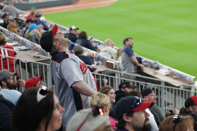 March 31, 2017, Atlanta, Georgia - A fan erupts in laughter and joy as a four Yankee players all converging on a ball fail to catch it at the Atlanta Braves Exhibition game in SunTrust Park where the Braves played the New York Yankees in Atlanta, Georgia, on March 31, 2017. (HENRY TAYLOR / HENRY.TAYLOR@AJC.COM)