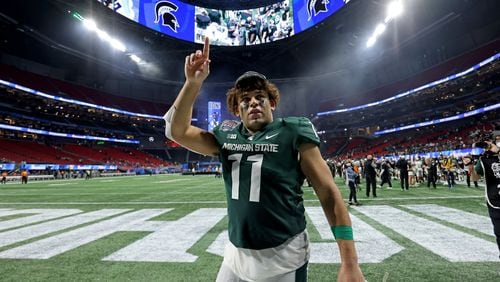 Dec. 30, 2021 - Atlanta, Ga: Michigan State Spartans tight end Connor Heyward (11) celebrates with fans after their 31-21 win against the Pittsburgh Panthers during the Chick-fil-A Peach Bowl at Mercedes-Benz Stadium in Atlanta, Thursday, December 30, 2021. Hayward is a graduate of Peachtree Ridge high school. JASON GETZ FOR THE ATLANTA JOURNAL-CONSTITUTION



